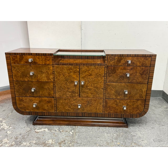 Design Plus Gallery presents a Bourbon Cloche Sideboard by Michael Amini for Aico. This substantial case piece pairs a...