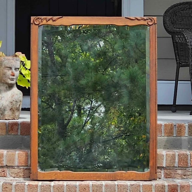 Hand-Carved Flourishes | Deep Beveled Glass | Authentic Wood Plank Back This is a magnificent Antique Oak Beveled Wall...