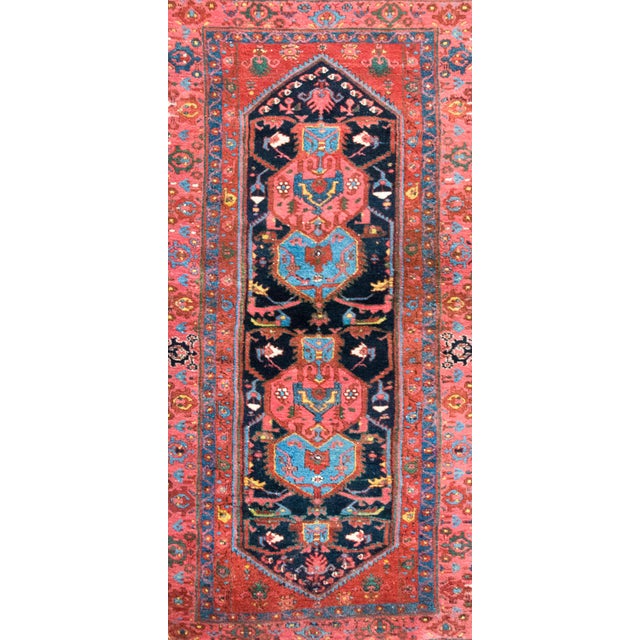 Woven in the early 20th century in western Iran, this Persian Hamadan rug features a striking central medallion filled...