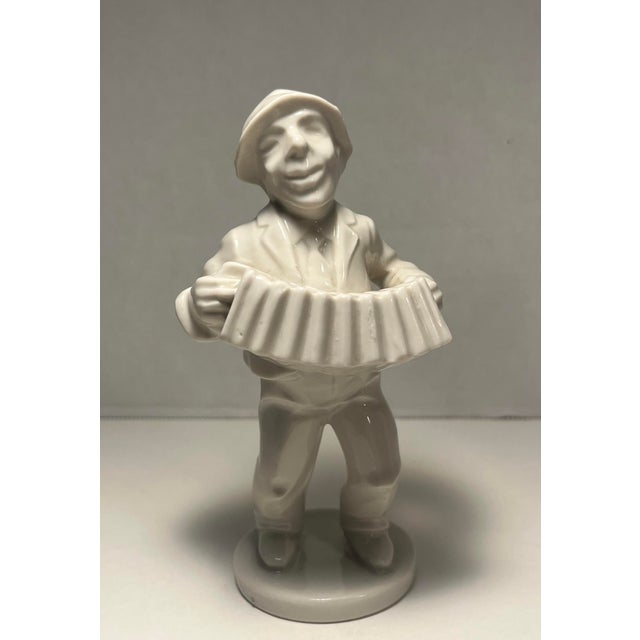 Charming set of three Dresden porcelain figurines depicting orchestra musicians, including an accordion player, a cellist,...