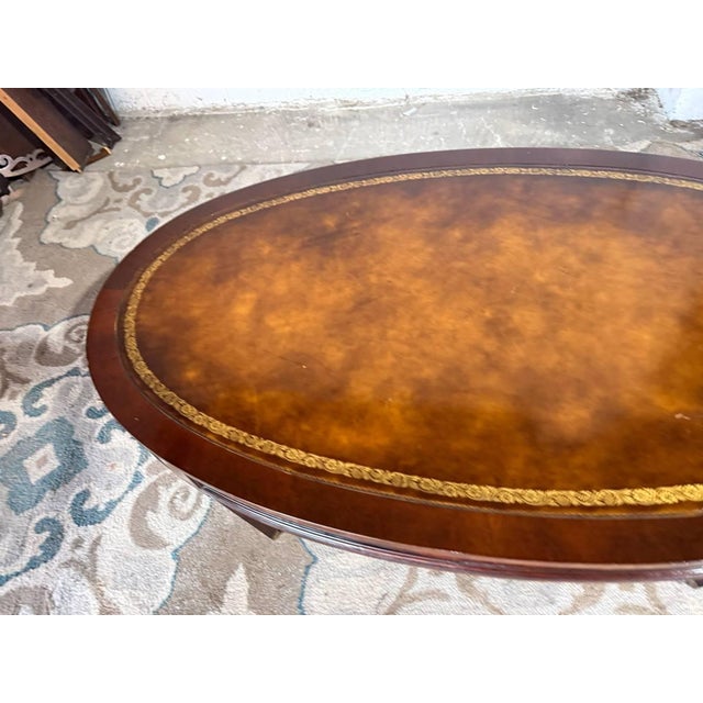 Mid 20th Century Vintage Regency Style Oval Leather Top Flame Mahogany Coffee Table on Casters. By Weiman. For Sale - Image 5 of 11