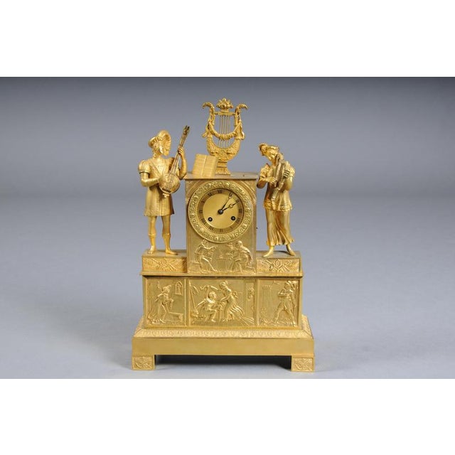 Gilt Bronze Empire Mantel Clock, Pairs, 1850 Finely chased and gilt bronze mantel clock. The motif depicts a couple...