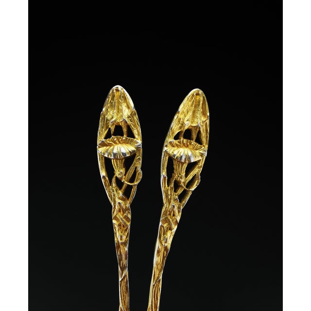 A complete 14-piece Art Nouveau silver-gilt tea service featuring a naturalistic design of finely crafted flowers and...