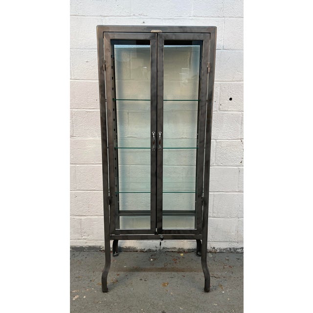 Add industrial character and vintage charm to your home or business with this stylish metal and glass doctor's display...