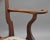 18th Century walnut open armchair in the Queen Anne style, having a shaped central splat flanked by curved uprights, the...