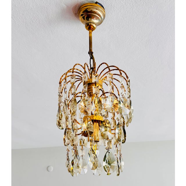 Add a touch of timeless French romance to the cozy corners of your home with this exquisite vintage waterfall crystal...