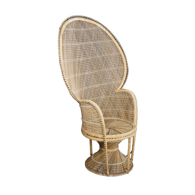 This vintage mid-century bohemian rattan peacock chair is a striking statement piece featuring an iconic, oversized...