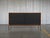 Paul McCobb Planner Group Model 1514 Iron Base Credenza with Black Pegboard Sliding Doors, Late 1950s An exceptional Paul...