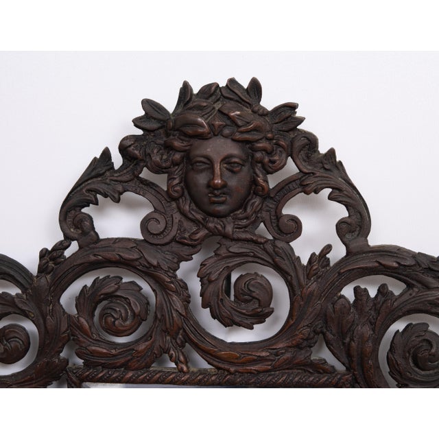 Very nice Cast Bronze wall Mirror. Decorated with women's heads comes with a beveled Mirror. Nice Antique Mirror.