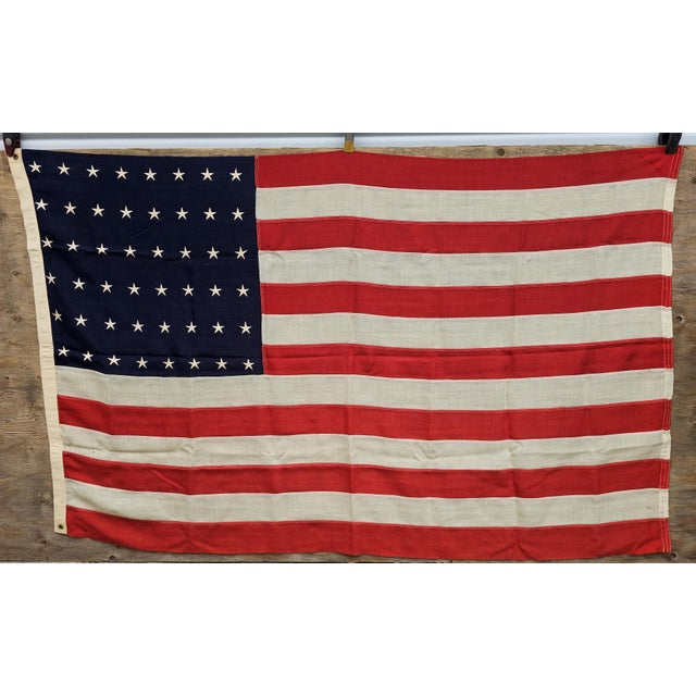 An authentic vintage 48-star United States flag measuring approximately 46.25 inches by 74 inches, representing one of the...