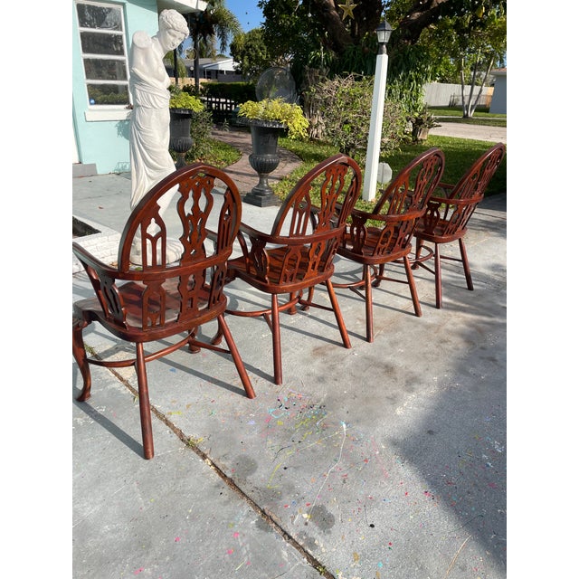Beautiful set of four classic chairs by Theodore & Alexander, featuring elegant openwork backs, curved arms, and graceful...