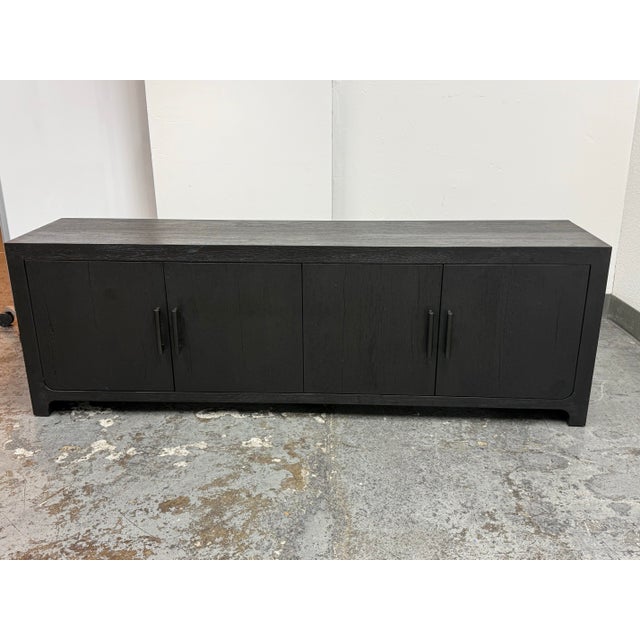Design Plus Gallery presents a Davos Oak Media Console in Aged Black Oak from Restoration Hardware. The oak case displays...