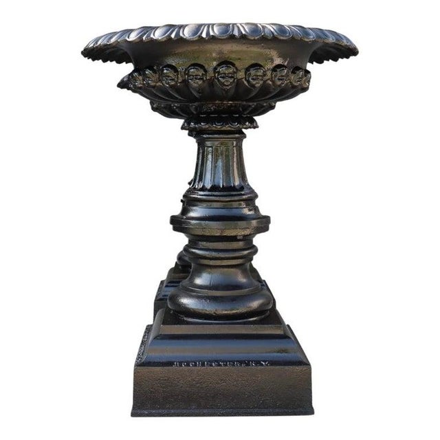 A distinguished pair of large antique cast iron garden urns, produced by the Co-operative Foundry Company, Rochester,...