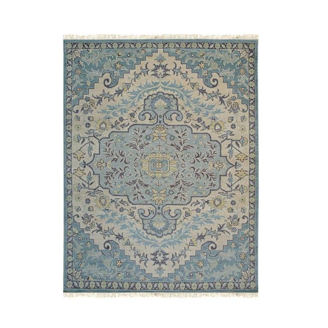 This blue wool rug features a hand knotted pile construction and is crafted in India. The design utilizes a classic...