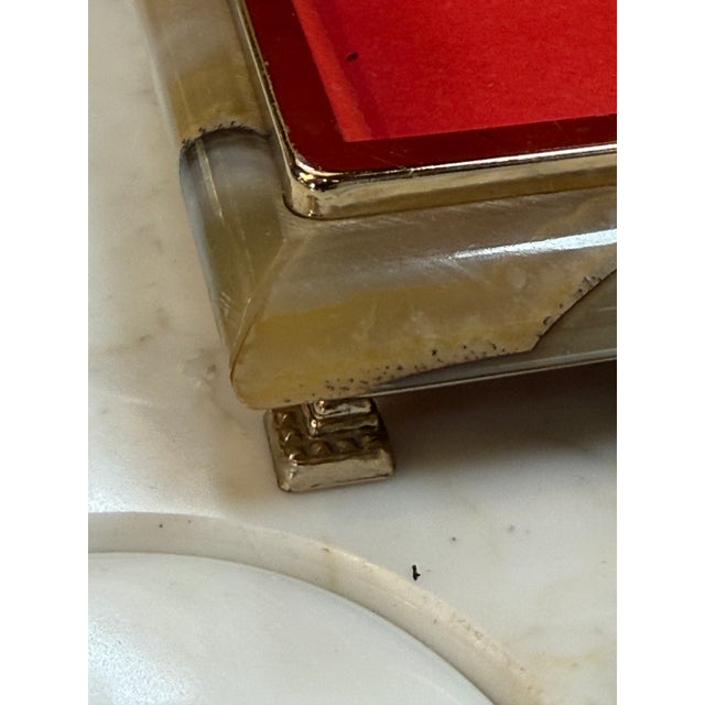 This richly detailed Italian decorative box showcases a polished onyx-style exterior with warm earth tones and distinctive...