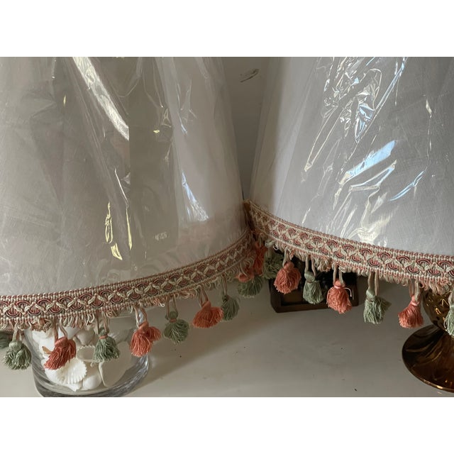 Pair of white Lamp Shades decorated with fringed trim.