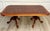Here is a sophisticated coffee table in the English Georgian Revival style featuring a richly figured burl veneer top...