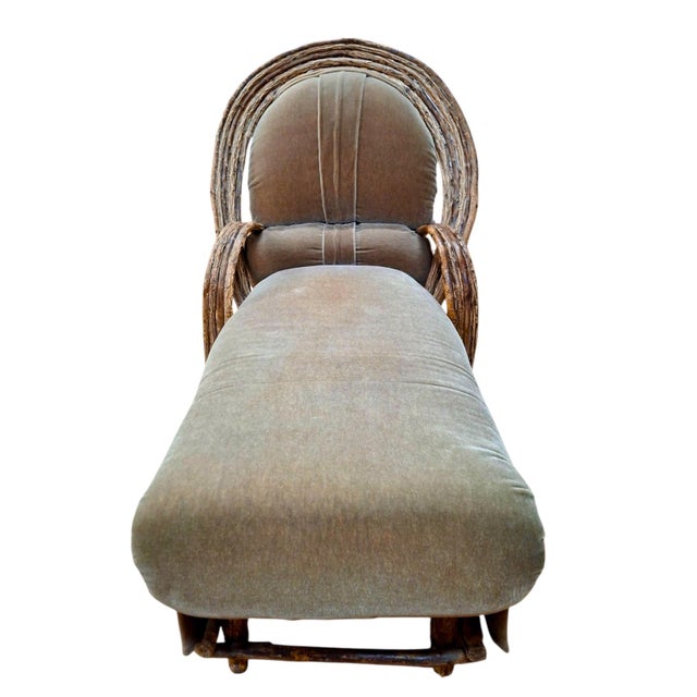 On offer is a vintage upholstered bent willow Adirondack chaise lounge, showcasing the classic rustic "twig" craft...