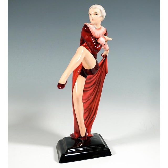 Exquisite porcelain figurine of the 1930: aparte dancer in a tight-fitting red costume with short trouser legs and ruff,...