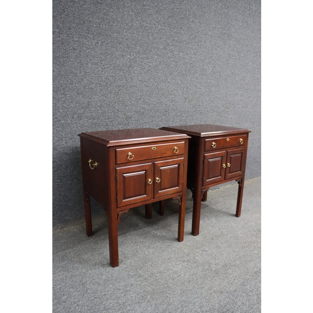 Pair of Statton Trutype Americana nightstands in solid cherry. One drawer over a two-door cabinet with brass hardware....