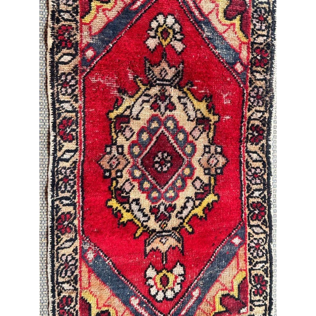 Pretty small distressed Turkish rug with nice geometrical design and beautiful colours, entirely hand knotted with wool on...