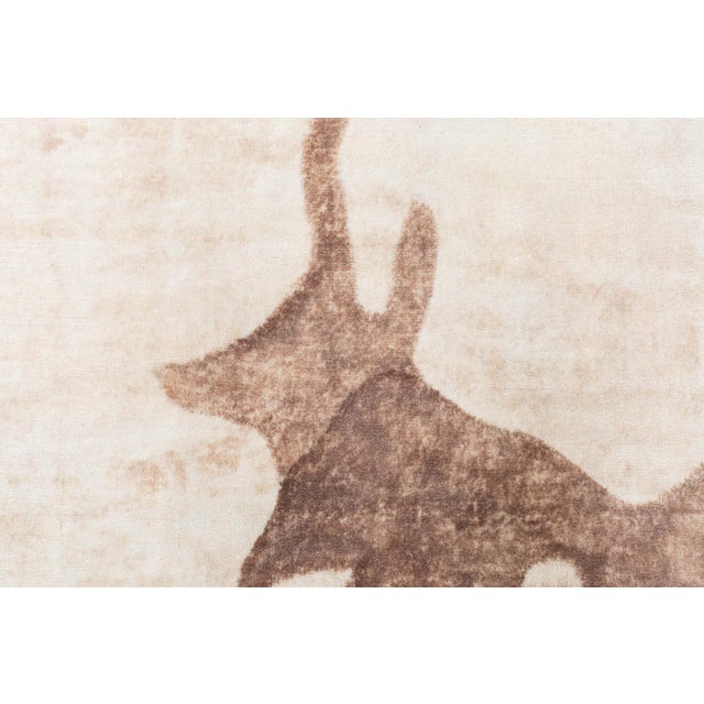 Inspired by natural forms and expressive abstraction, this striking contemporary wool rug invites both movement and...