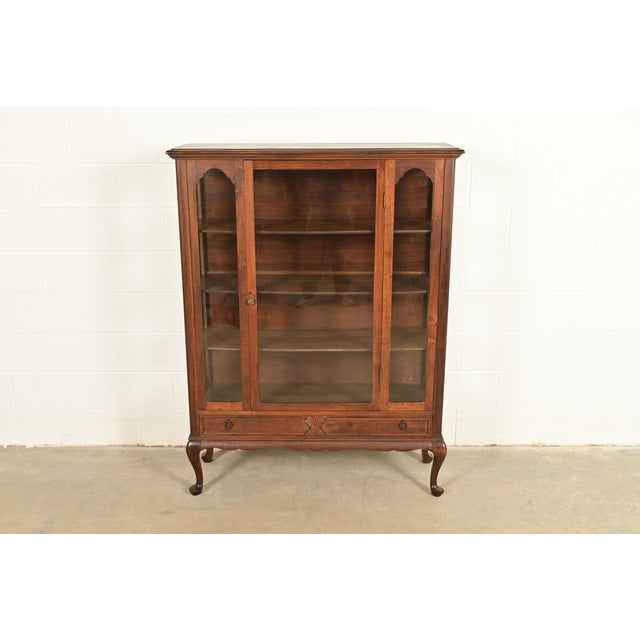 A gorgeous antique Queen Anne or Victorian style bookcase, bar cabinet, or dining cabinet In the manner of Berkey & Gay...