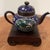 The product is an antique Japanese cloisonné Meiji period teapot with a beautiful blue enamel body featuring a phoenix...