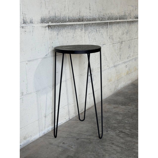 This tall pedestal features a distinctive round top suspended on an airy base. The clean silhouette beautifully showcases...
