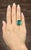 This exquisite cocktail ring is expertly crafted in platinum, featuring a striking green natural emerald as its...