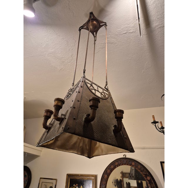Impressive early 20th century light fixture handcrafted in hammered copper , with ceiling crown and four copper rods...