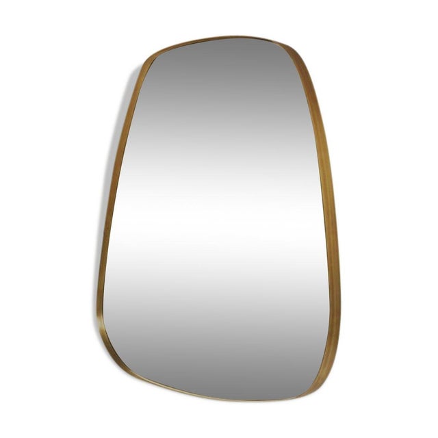 Free-form mirror on a brass frame. Well-made, simple and delicate.