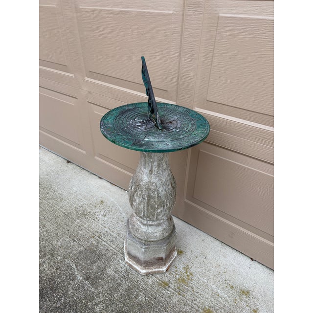 A stunning vintage English country or Neoclassical style verdigris iron garden sundial on a cast concrete pedestal base....