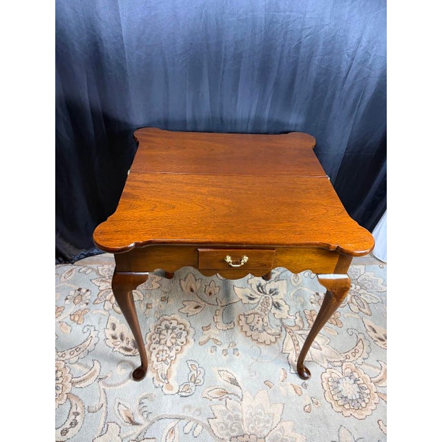 Curator Notes: A marvel of space-saving historical utility, this charming vintage Queen Anne style flip-top table...