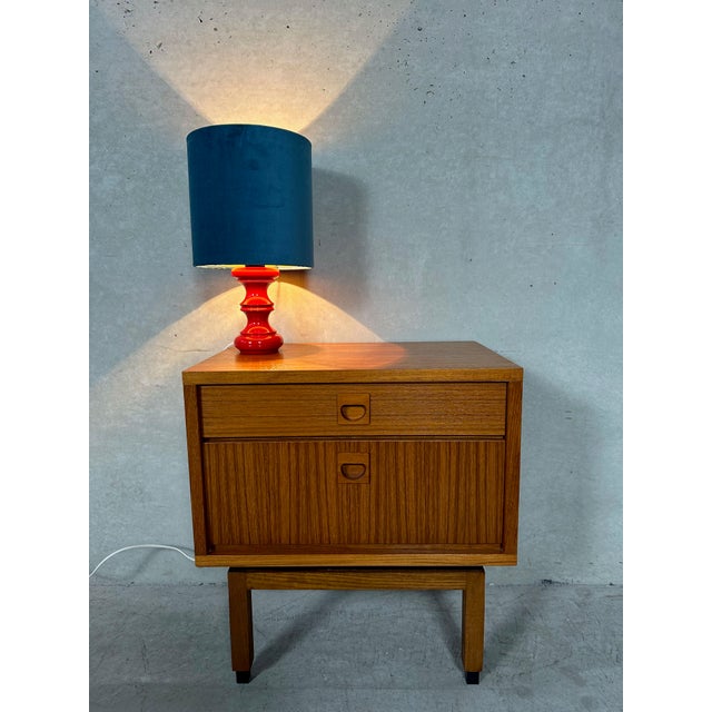 Vintage teak table. Can serve as a bedside table or side table. One drawer and one storage compartment behind the hinged...