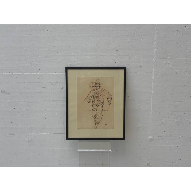 A delicate, expressive lithograph of a harlequin, rendered with a reduced linework, its lightness and movement creating an...