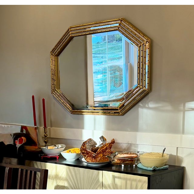 Striking vintage gilt faux-bamboo wall mirror by Carolina Mirror Company, featuring a distinctive elongated octagonal form...