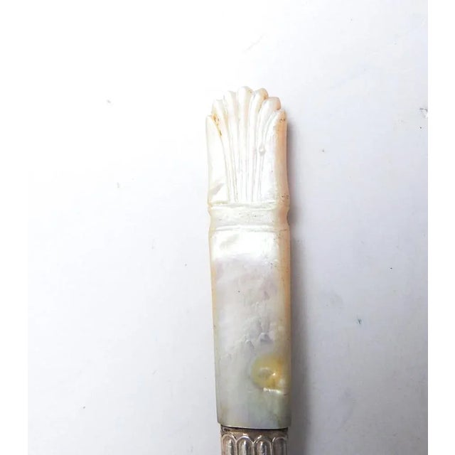Set of 5 antique late 19th century mother of pearl carved handle nut picks with silverplate ferrule and steel picks....