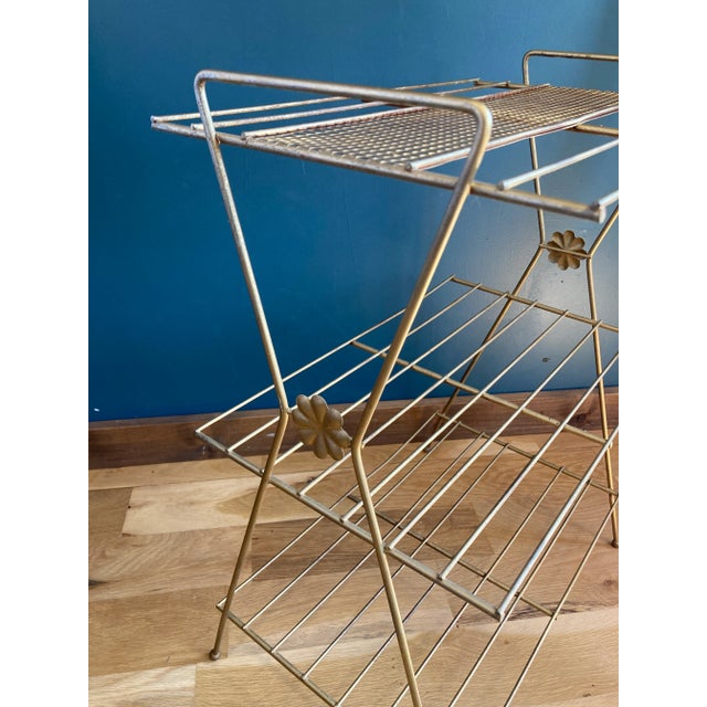 This vintage Mid-Century Modern plant stand brings sculptural charm and versatile function to any space. Featuring a...