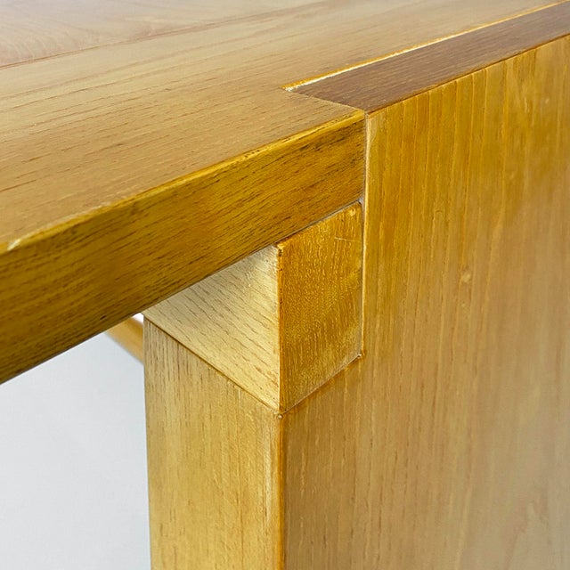 Valmarana model table, made entirely of wood with a light finish and a rectangular top, composed of two lateral shoulders...