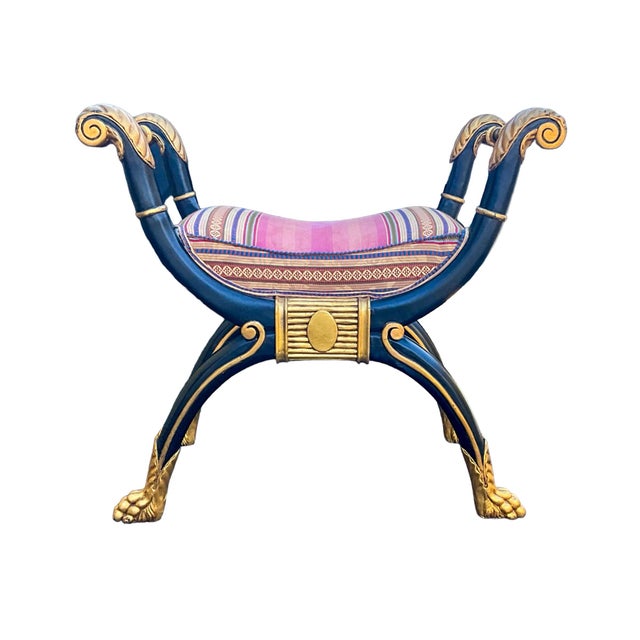 This is a neo-classical style bench with an ebonized frame and gilt accents. It is attributed to Maitland -Smith and dates...