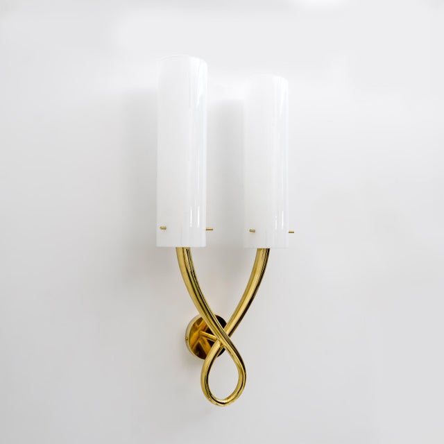 Pair of Gio Ponti style wall lamps. The body of the chandelier features two cylindrical white Murano Incamiciato glass...