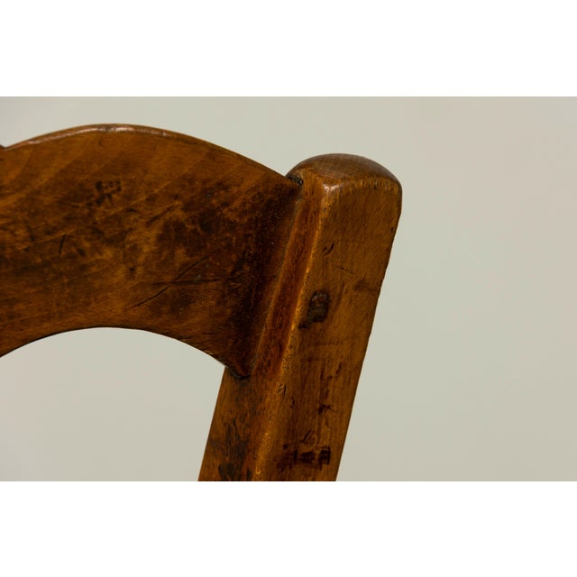 Charming set of 14 petite mid-19th century French Provincial dining chairs, sourced in Provence, France. Crafted in solid...