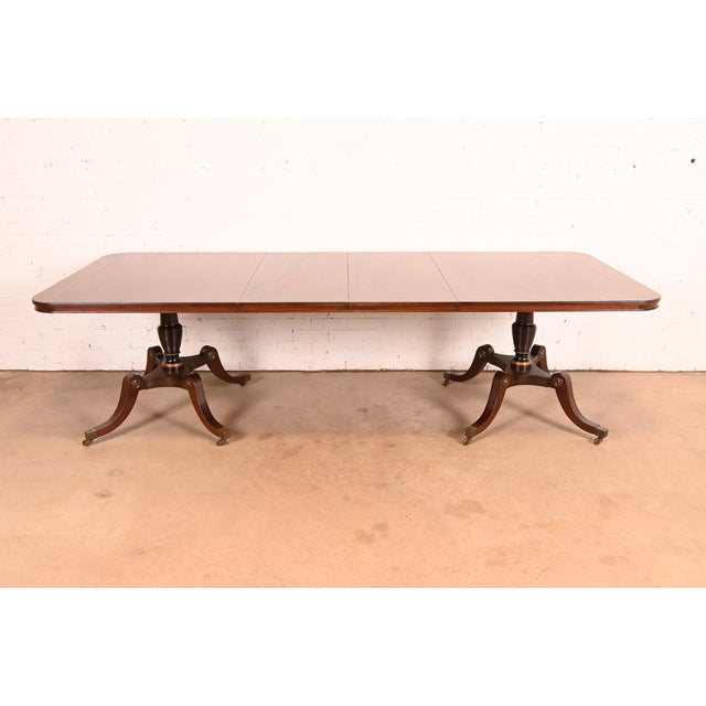 An exceptional antique Georgian or Regency style double pedestal extension dining table By Kittinger USA, Circa 1960s...