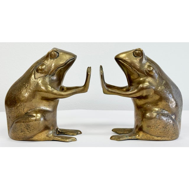 Vintage pair of solid brass bookends in the shape of detailed frogs facing each other on hind legs. Dimensions are per...