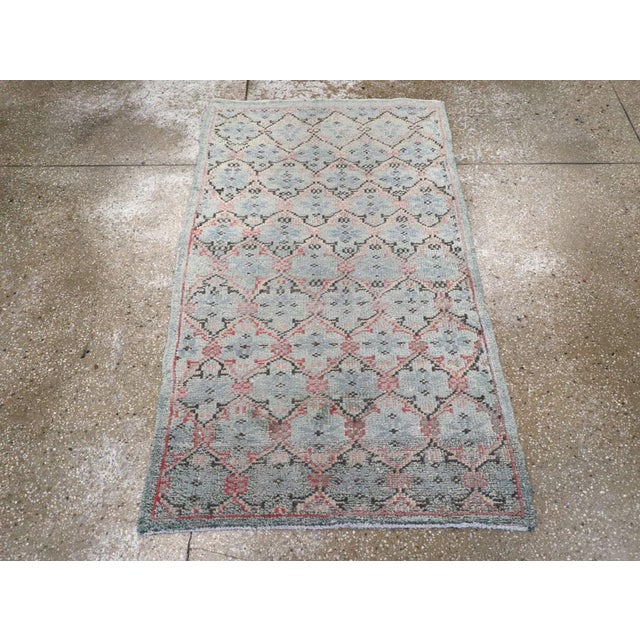 A vintage Turkish Anatolian throw rug. A slightly curvy field tone lattice closely frames an offset, half-drop array of...