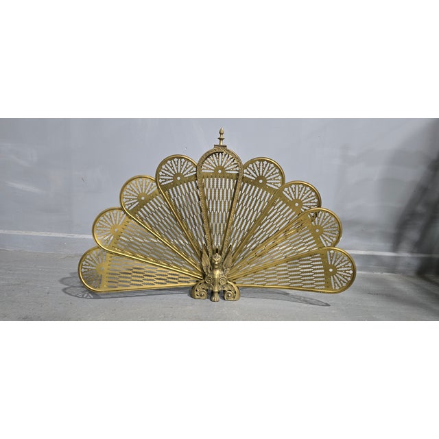 A very good brass peacocl adjustable fire sreen, in overall very good original condition. 24" high 38" wide