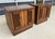 This pair of 1970s Brutalist-inspired nightstands, made in Canada, features bold geometric door fronts, warm wood tones,...