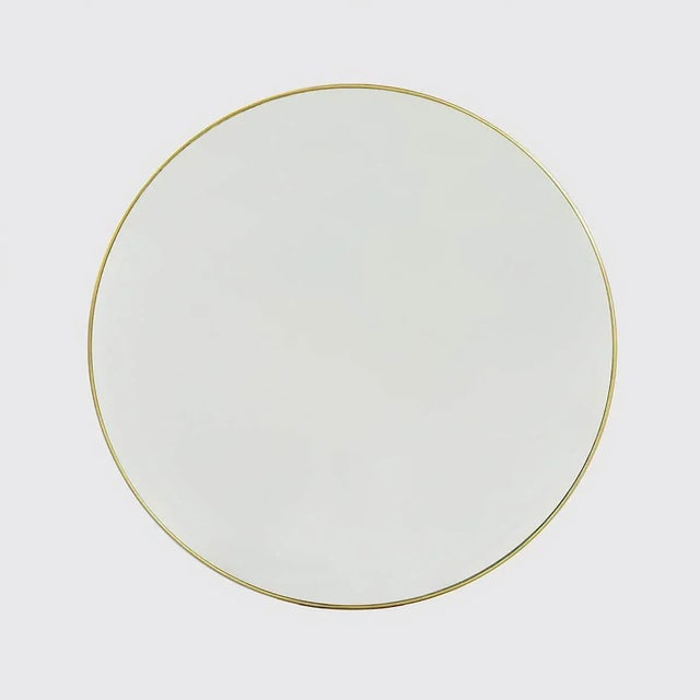 Mid Century Modern gilt finish round metal frame wall mirror with a clear glass plate. Dimensions: 32" W x 1" D x 32" H