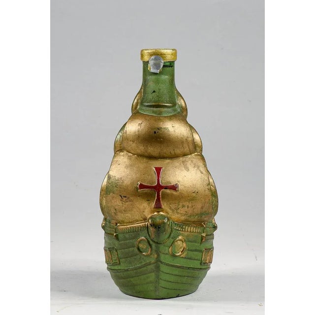 Closed glass bottle in the shape of a galleon green and gold sailing ship containing vinsanto bertocchini livorno with...